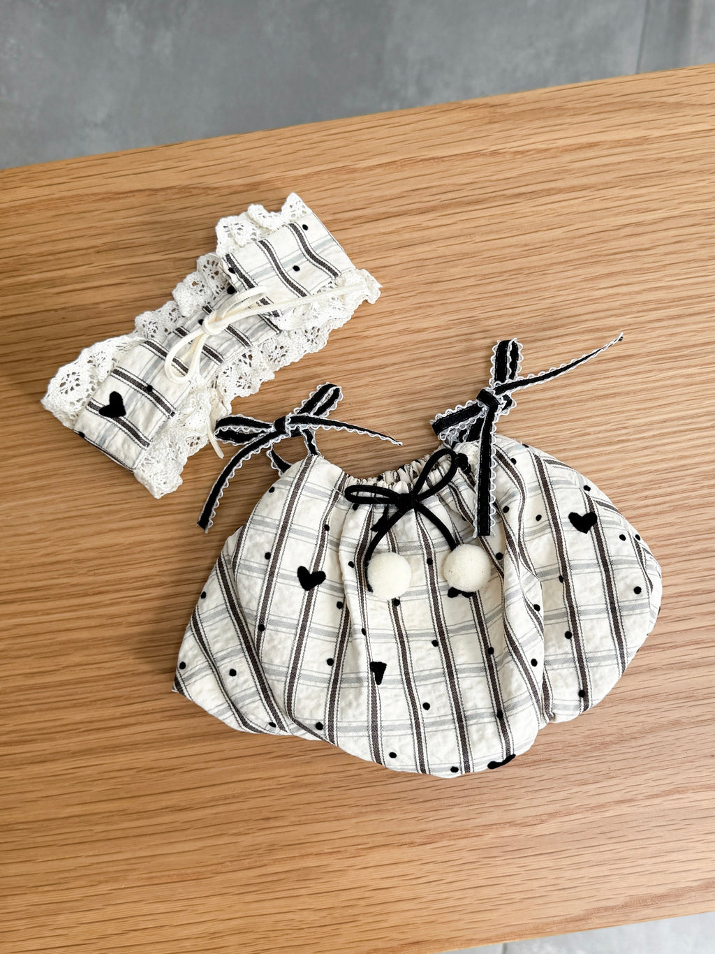 Heart-detail dress with pom-poms and matching lace-trimmed bonnet for a plush toy
