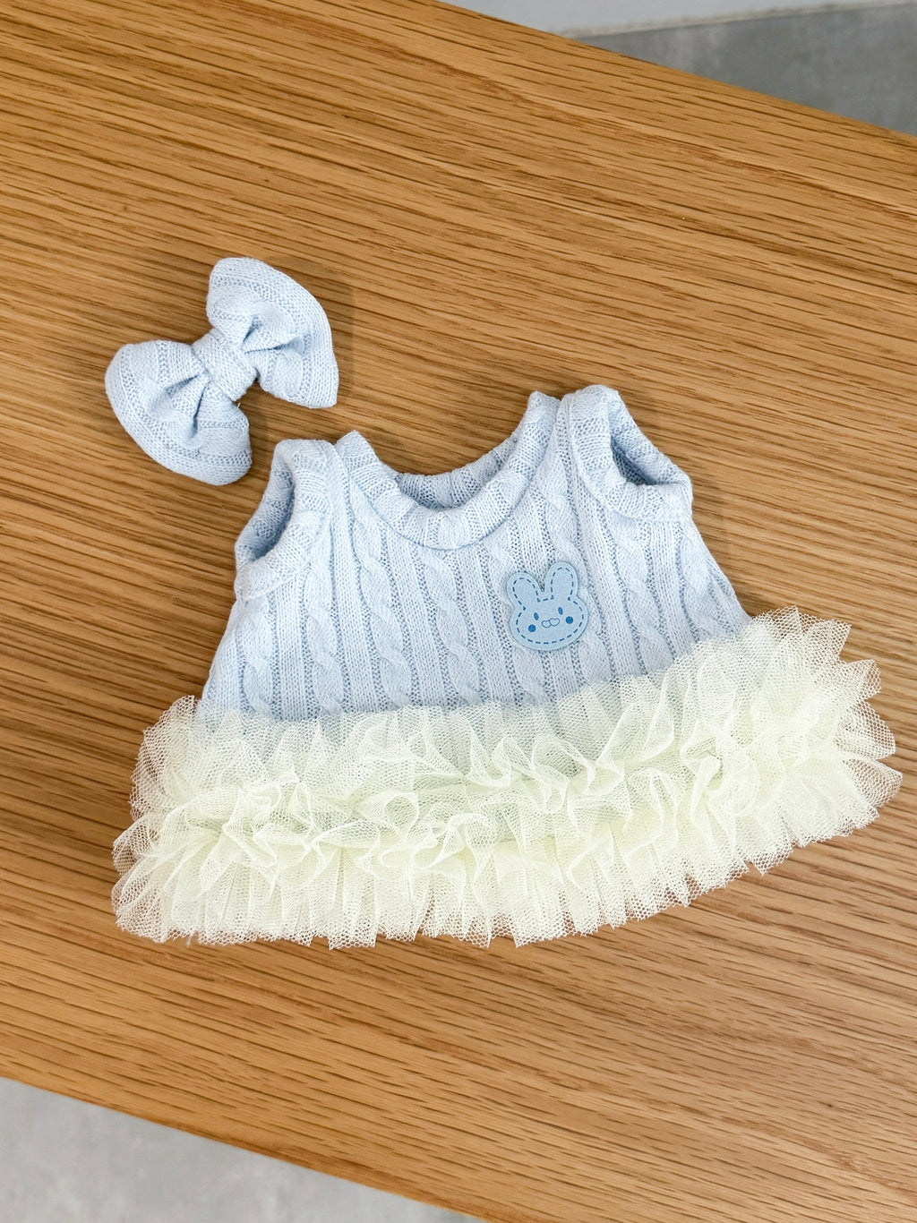 Baby blue cable knit tutu dress for a plush bunny with layered ivory tulle and matching bow hair clip