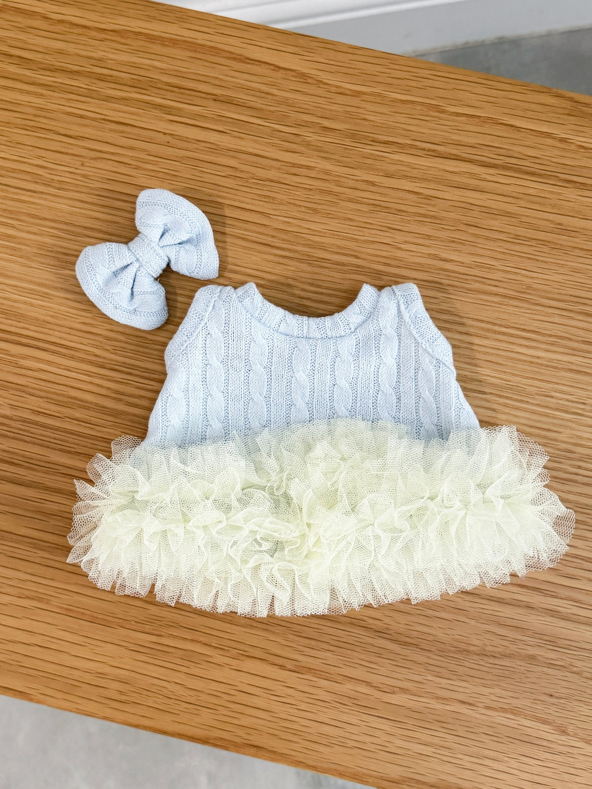 Back view of  baby blue cable knit tutu dress for a plush bunny with matching bow hair clip
