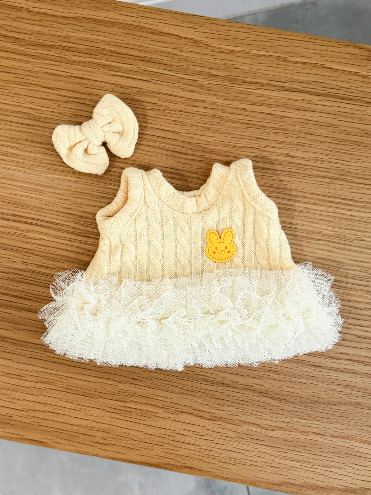 Soft yellow cable knit tutu dress and matching bow for a plush bunny