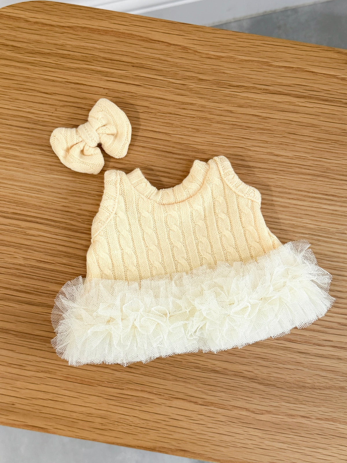 Back view of soft yellow cable knit tutu dress for a plush bunny with ribbon tie