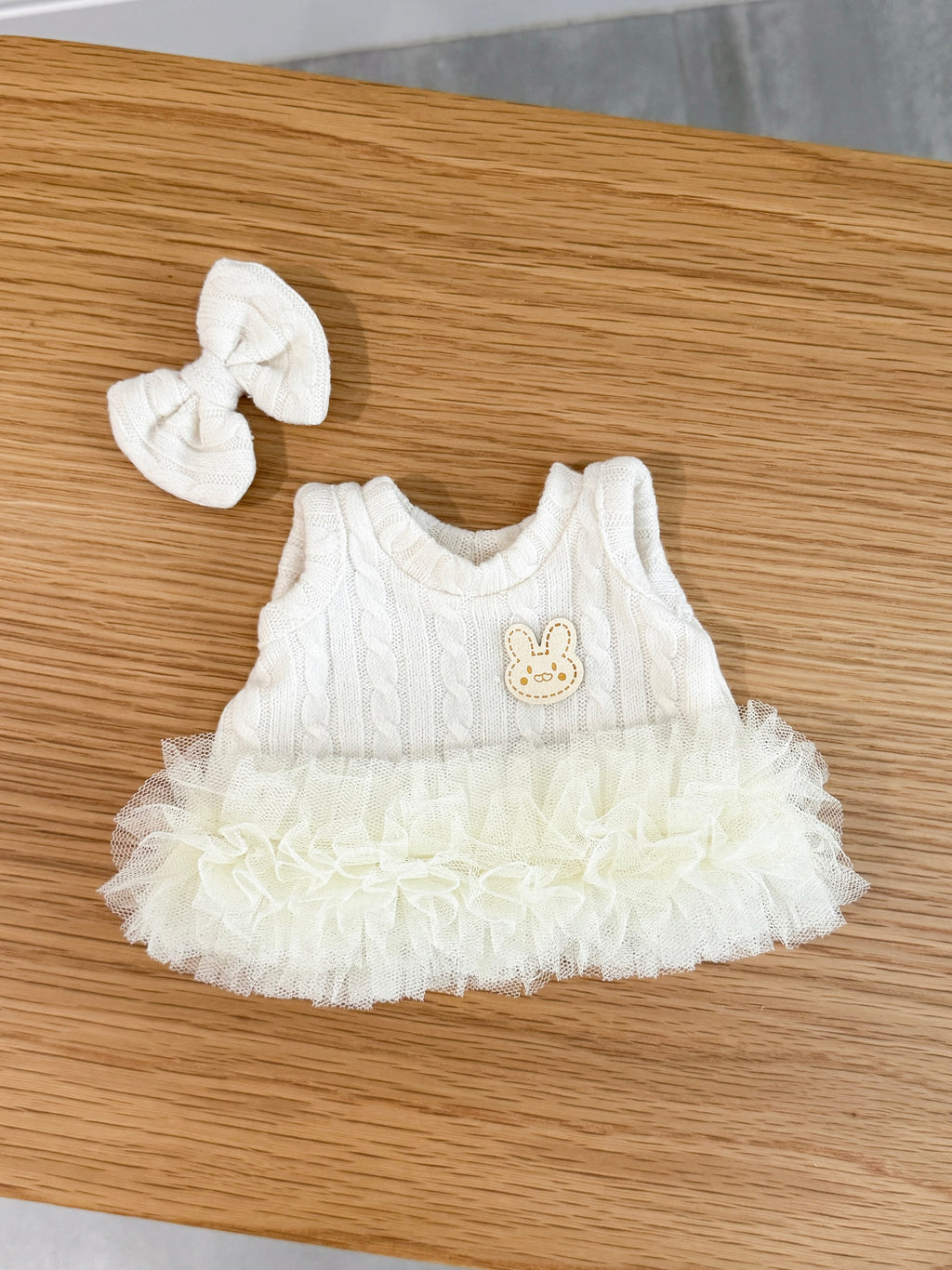Ivory cable knit tutu dress for a plush bunny with layers of tulle and matching bow hair clip