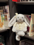 Silver plush bunny wearing a cream cable knit cardigan with bear-shaped buttons