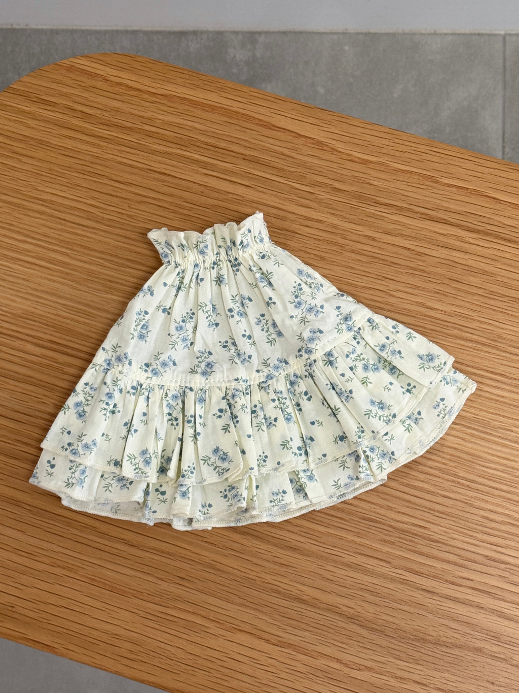 Blue floral tiered dress for a plush bunny with gathered neckline and layered ruffle skirt