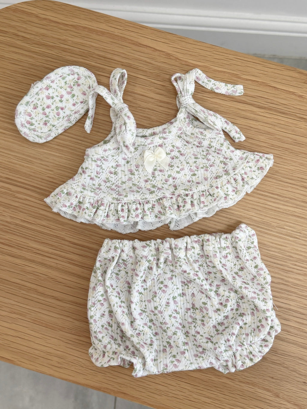 Pink floral three-piece outfit for a plush bunny with ruffled cami top, bloomer shorts and matching sleep mask
