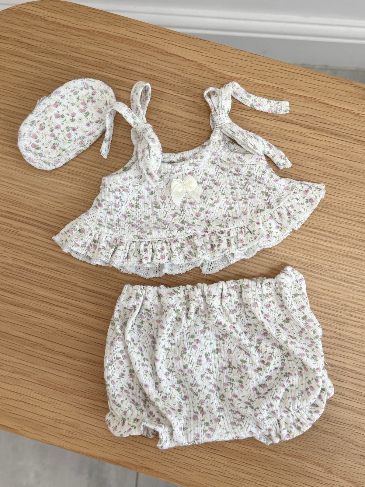 Pink floral three-piece outfit for a plush bunny with ruffled cami top, bloomer shorts and matching sleep mask