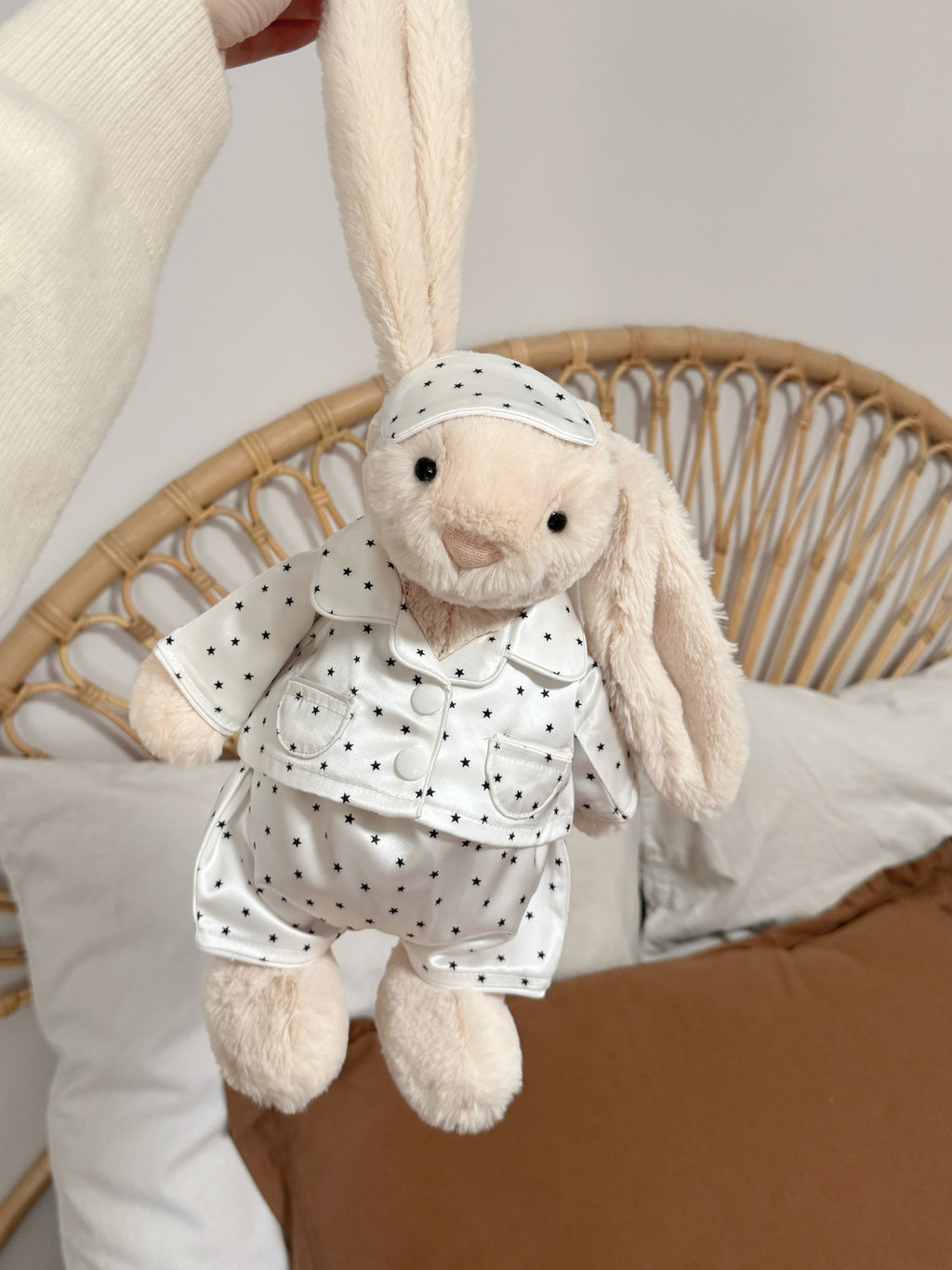 Cream plush bunny wearing a white star print pyjama set with matching sleep mask