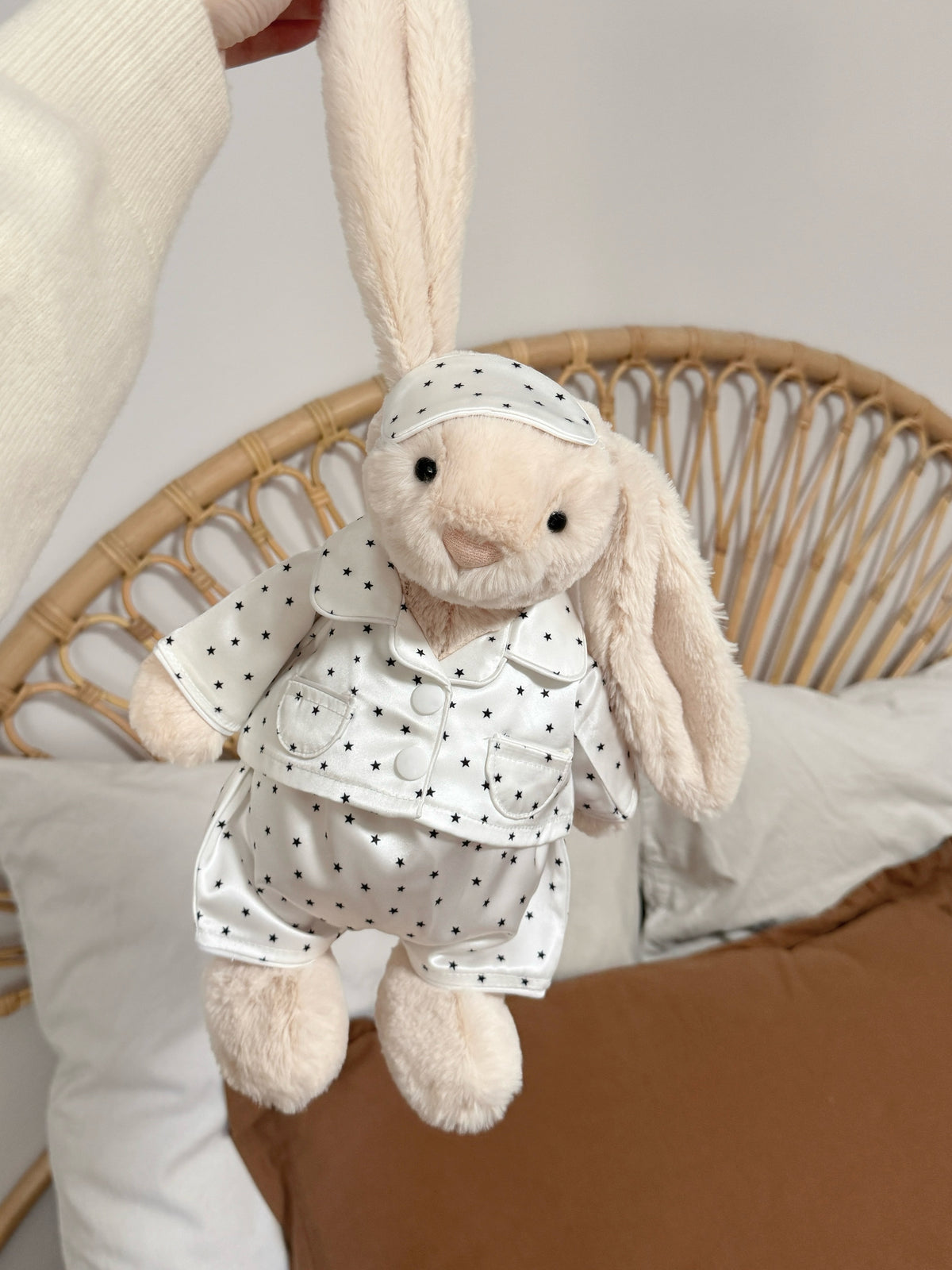 Cream plush bunny wearing a white star print pyjama set with matching sleep mask
