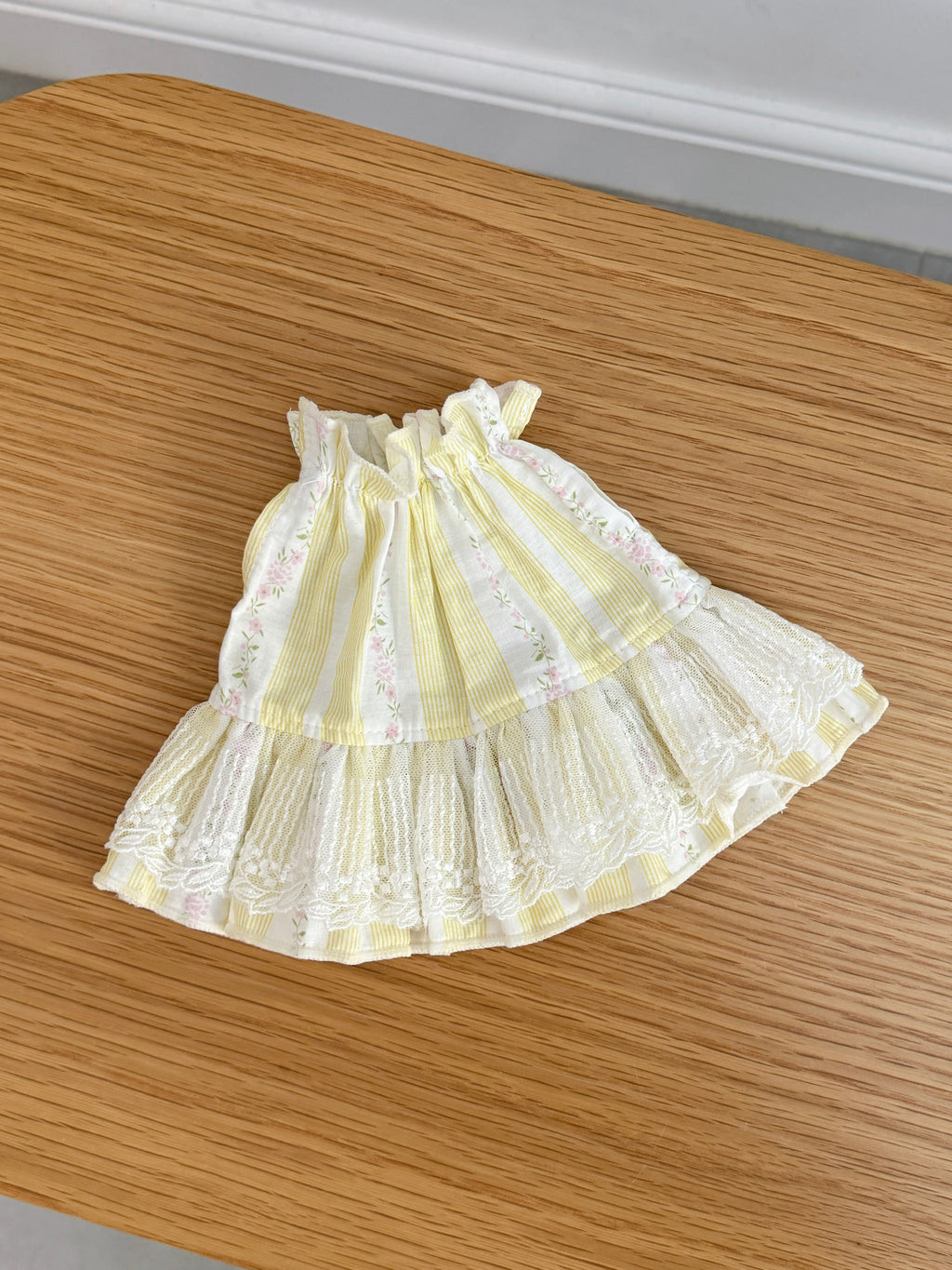 Yellow and cream striped plush bunny dress with pink floral details and ivory lace