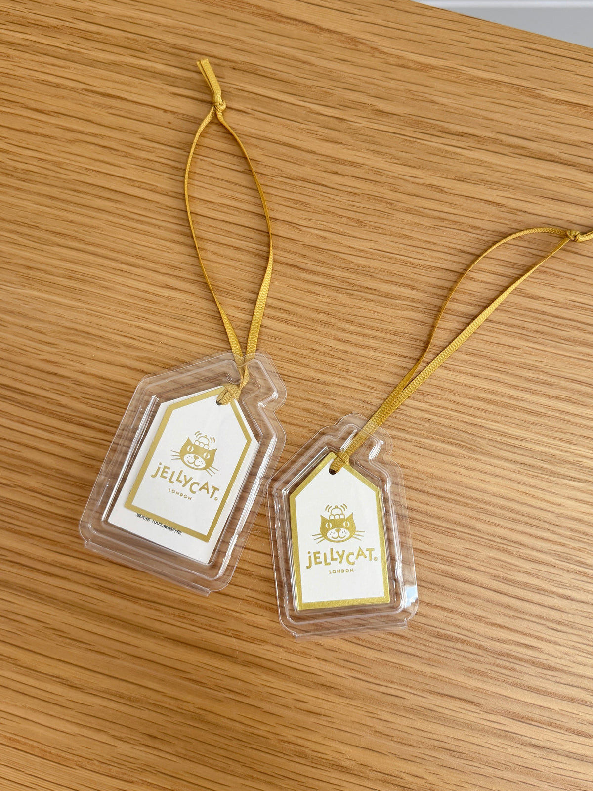 Small and large clear tag protectors shown with different Jellycat swing tag sizes