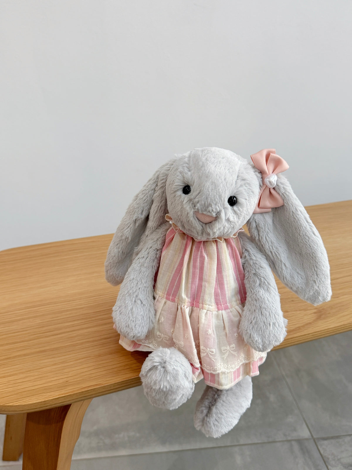 Silver plush bunny wearing a pink and cream striped dress with ivory embroidered lace